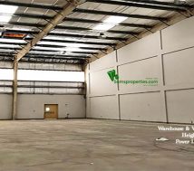 An industrial warehouse approved for workshops and storage. The Width is 23.20 meters, length is 13 meters, and the height is 11 meters. At the back, there is a ventilation window and a door to the backyard. The roofing is fitted with small transparent sheets to let the sunlight come inside. The front area is a tarred path for heavy vehicles for loading and unloading.