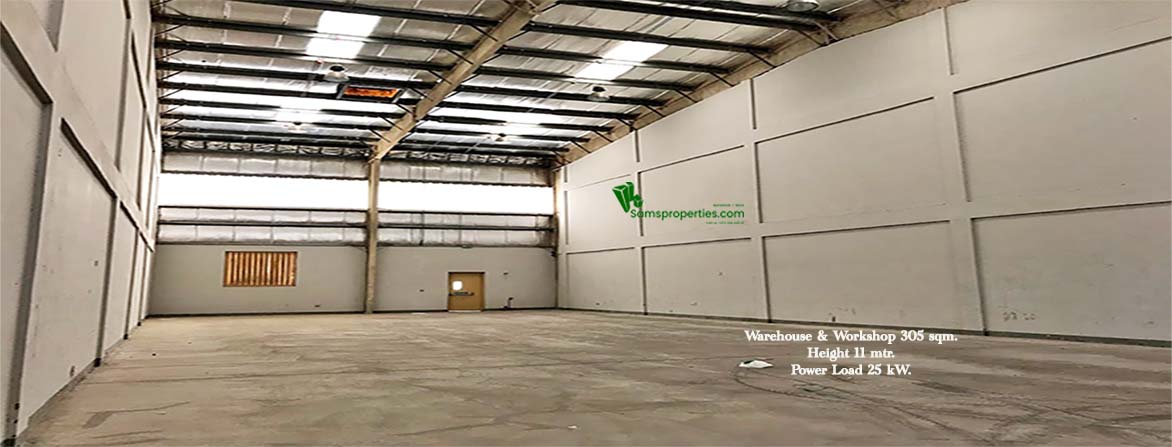 An industrial warehouse approved for workshops and storage. The Width is 23.20 meters, length is 13 meters, and the height is 11 meters. At the back, there is a ventilation window and a door to the backyard. The roofing is fitted with small transparent sheets to let the sunlight come inside. The front area is a tarred path for heavy vehicles for loading and unloading.