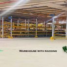 Inside a spacious, Civil Defence-approved warehouse for rent in Ras Zuwayed, Bahrain, featuring extensive racking, an 11-meter ceiling, high power load, multiple loading bays, and visible fire protection systems. A Samsproperties.com logo is present. A large warehouse of 2060 square meters (27986 Sqft). Warehouse for storage, Industrial workshop and factory.