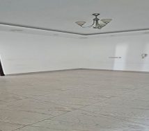 An empty office space showing two dark-colored doors, one of which is a main entrance.