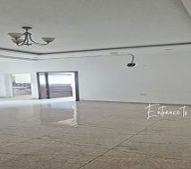 An empty office space with white walls and a tiled floor. The lowest rent office in Hidd, Bahrain, 100 square meters for BHD 200 per month (BHD 2 per square meter). An idle startup office in Bahrain