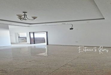 An empty office space with white walls and a tiled floor. The lowest rent office in Hidd, Bahrain, 100 square meters for BHD 200 per month (BHD 2 per square meter). An idle startup office in Bahrain