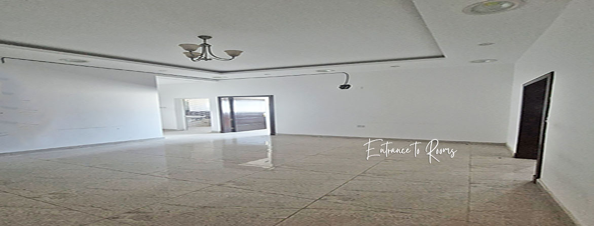 An empty office space with white walls and a tiled floor. The lowest rent office in Hidd, Bahrain, 100 square meters for BHD 200 per month (BHD 2 per square meter). An idle startup office in Bahrain