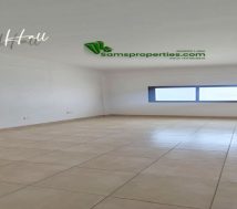 Large hall area with tiled flooring and natural lighting in a two-bedroom flat for rent in Riffa, Bahrain.