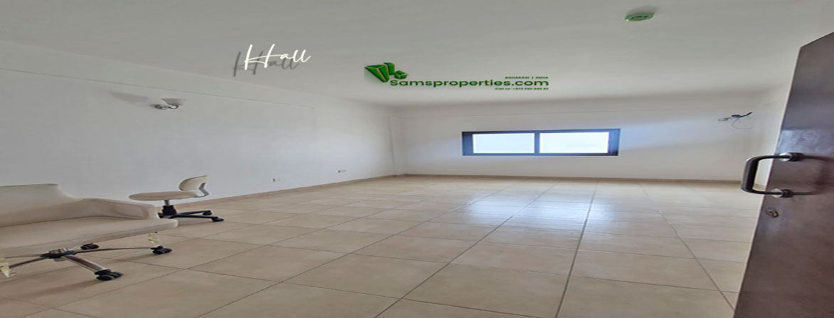 Large hall area with tiled flooring and natural lighting in a two-bedroom flat for rent in Riffa, Bahrain.