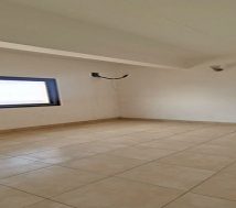 Bright and clean bedroom area in a two-bedroom worker flat for rent in Riffa, Bahrain.
