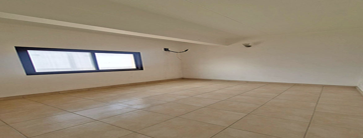 Bright and clean bedroom area in a two-bedroom worker flat for rent in Riffa, Bahrain.