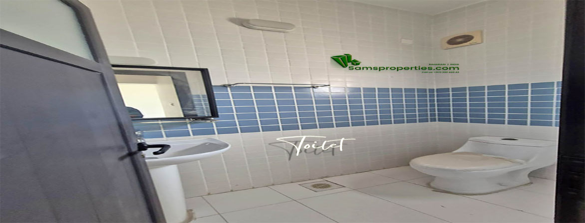 Clean and modern bathroom with blue and white tiles in a worker flat for rent in Riffa, Bahrain.
